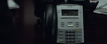 Movie still from “Batman v Superman: Dawn of Justice” (2016), directed by Zack Snyder – A phone on a desk; Extreme Close Up shot, High angle