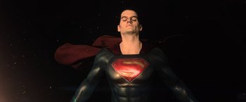 Movie still from “Batman v Superman: Dawn of Justice” (2016), directed by Zack Snyder – A man in a superman costume with his eyes closed; Medium shot, Low angle