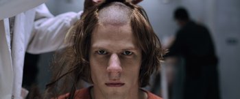 Movie still from “Batman v Superman: Dawn of Justice” (2016), directed by Zack Snyder – A person with a shaved head; Close Up shot, Over the shoulder angle