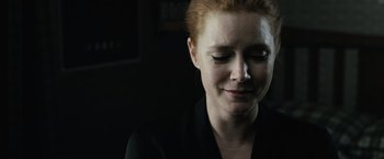 Movie still from “Batman v Superman: Dawn of Justice” (2016), directed by Zack Snyder – A person wearing a black shirt; Close Up shot, Over the shoulder angle