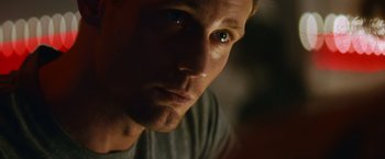 Movie still from “Battleship” (2012), directed by Peter Berg – A man's face with a tear in his eye; Close Up shot, Low angle