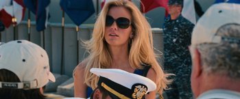 Movie still from “Battleship” (2012), directed by Peter Berg – A beautiful blond woman wearing sunglasses and a hat; Close Up shot, Over the shoulder angle