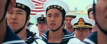 Movie still from “Battleship” (2012), directed by Peter Berg – A group of men in navy uniforms standing next to each other; Close Up shot, Low angle