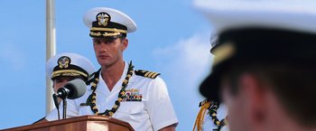 Movie still from “Battleship” (2012), directed by Peter Berg – A man in a military uniform stands in front of a crowd; Medium shot, Over the shoulder angle