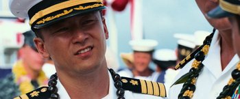 Movie still from “Battleship” (2012), directed by Peter Berg – A man in a sailor's hat and tie; Close Up shot, Over the shoulder angle