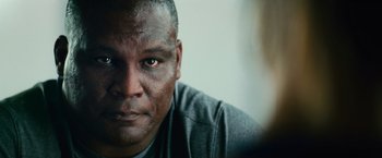 Movie still from “Battleship” (2012), directed by Peter Berg – A person's face with dirt all over his face; Close Up shot, Low angle