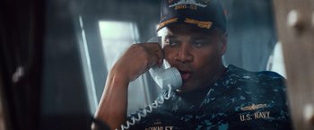 Movie still from “Battleship” (2012), directed by Peter Berg – A man talking on a phone while wearing a hat; Close Up shot, Low angle