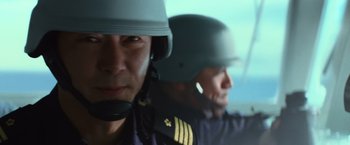 Movie still from “Battleship” (2012), directed by Peter Berg – Two men in military uniforms are wearing helmets; Close Up shot, Low angle