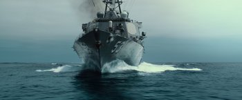Movie still from “Battleship” (2012), directed by Peter Berg – A large boat in the water with smoke coming out of it; Wide shot, Low angle