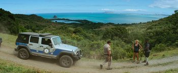 Movie still from “Battleship” (2012), directed by Peter Berg – A man walking on a dirt road next to a jeep; Extreme Wide shot, High angle