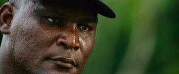 Movie still from “Battleship” (2012), directed by Peter Berg – A man's face wearing a hat; Extreme Close Up shot, Low angle
