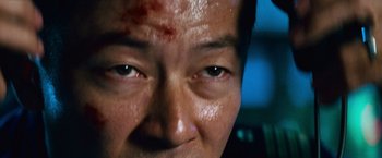 Movie still from “Battleship” (2012), directed by Peter Berg – A man's face with blood all over his face; Extreme Close Up shot, Low angle
