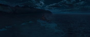 Movie still from “Battleship” (2012), directed by Peter Berg – A boat in the middle of the ocean under a cloudy night sky; Extreme Wide shot, High angle