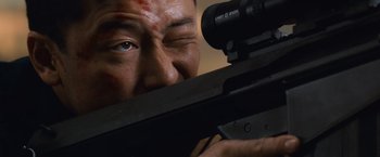 Movie still from “Battleship” (2012), directed by Peter Berg – A man holding a rifle and aiming at a target; Extreme Close Up shot, Low angle