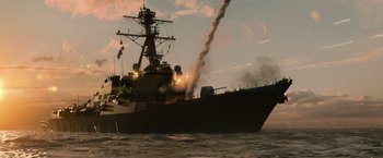 Movie still from “Battleship” (2012), directed by Peter Berg – A large boat is in the water with a lot of smoke coming out of it; Extreme Wide shot, Low angle