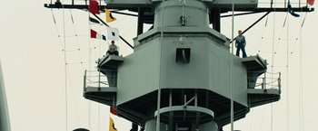 Movie still from “Battleship” (2012), directed by Peter Berg – A man sitting on the top of a boat; Wide shot, Low angle