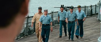 Movie still from “Battleship” (2012), directed by Peter Berg – A group of men walking across a pier; Wide shot, Low angle