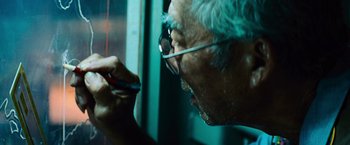 Movie still from “Battleship” (2012), directed by Peter Berg – An old man with glasses is looking at a cell phone; Extreme Close Up shot, Low angle