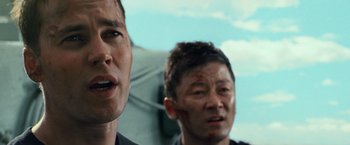 Movie still from “Battleship” (2012), directed by Peter Berg – Two asian men are standing together and one is bleeding from his face; Close Up shot, Low angle