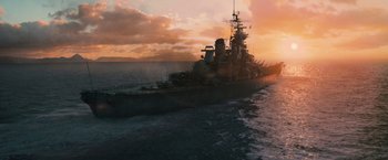Movie still from “Battleship” (2012), directed by Peter Berg – A boat in the ocean at sunset with the sun setting behind it; Extreme Wide shot, High angle