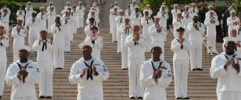Movie still from “Battleship” (2012), directed by Peter Berg – A large group of sailors standing on some steps; Wide shot, Low angle