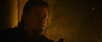 Movie still from “The Last Duel” (2021), directed by Ridley Scott – A man's face in the dark; Close Up shot, Over the shoulder angle