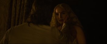 Movie still from “The Last Duel” (2021), directed by Ridley Scott – A woman is looking into a mirror in the dark; Close Up shot, Over the shoulder angle