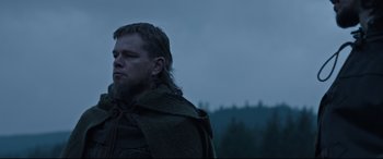 Movie still from “The Last Duel” (2021), directed by Ridley Scott – A man with long hair and a beard is wearing a cape; Close Up shot, Low angle