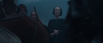 Movie still from “The Last Duel” (2021), directed by Ridley Scott – Two women standing next to each other in a field; Medium shot, Over the shoulder angle