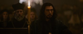 Movie still from “The Last Duel” (2021), directed by Ridley Scott – A man standing next to a candle in a room; Close Up shot, Over the shoulder angle