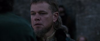 Movie still from “The Last Duel” (2021), directed by Ridley Scott – A person with long hair and a beard; Close Up shot, Over the shoulder angle