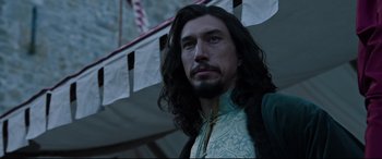 Movie still from “The Last Duel” (2021), directed by Ridley Scott – A person with long black hair; Close Up shot, Over the shoulder angle