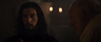 Movie still from “The Last Duel” (2021), directed by Ridley Scott – A man with long black hair is looking at a man with bald head; Close Up shot, Over the shoulder angle