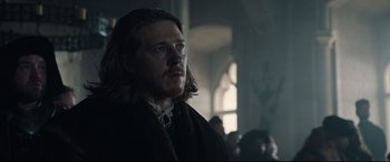 Movie still from “The Last Duel” (2021), directed by Ridley Scott – A person wearing a robe; Close Up shot, Over the shoulder angle