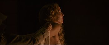 Movie still from “The Last Duel” (2021), directed by Ridley Scott – A woman with long blonde curly hair wearing a white dress; Medium shot, Over the shoulder angle