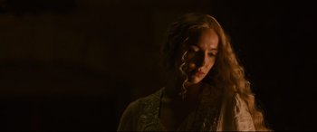 Movie still from “The Last Duel” (2021), directed by Ridley Scott – A woman with long blonde curly hair wearing a white shirt; Close Up shot, Over the shoulder angle