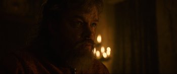 Movie still from “The Last Duel” (2021), directed by Ridley Scott – A man with a long beard is looking at the camera; Close Up shot, Over the shoulder angle