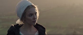 Movie still from “The Last Duel” (2021), directed by Ridley Scott – A woman with a white head scarf looking to her left; Close Up shot, Over the shoulder angle