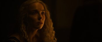 Movie still from “The Last Duel” (2021), directed by Ridley Scott – A woman with long blonde curly hair looking to her left; Close Up shot, Over the shoulder angle