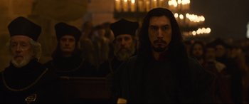 Movie still from “The Last Duel” (2021), directed by Ridley Scott – A group of people in a dark room with candles; Medium shot, Over the shoulder angle