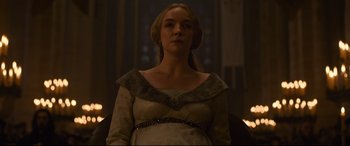 Movie still from “The Last Duel” (2021), directed by Ridley Scott – A woman in a white dress sitting in a chair; Medium shot, Low angle