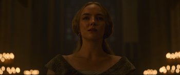 Movie still from “The Last Duel” (2021), directed by Ridley Scott – A woman with long blonde hair wearing a gray dress; Close Up shot, Low angle