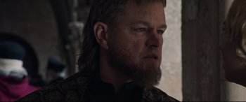 Movie still from “The Last Duel” (2021), directed by Ridley Scott – A person with long hair and a beard; Close Up shot, Over the shoulder angle