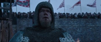 Movie still from “The Last Duel” (2021), directed by Ridley Scott – A person wearing a chain mail hood; Close Up shot, Low angle