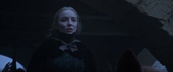 Movie still from “The Last Duel” (2021), directed by Ridley Scott – A woman wearing a black dress and a black bow tie; Close Up shot, Low angle