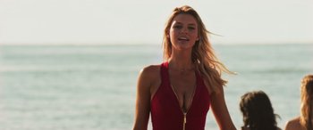 Movie still from “Baywatch” (2017), directed by Seth Gordon – A beautiful blonde woman in a red bathing suit on the beach; Close Up shot, Low angle