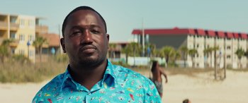 Movie still from “Baywatch” (2017), directed by Seth Gordon – A person wearing a blue shirt; Close Up shot, Low angle