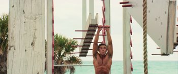 Movie still from “Baywatch” (2017), directed by Seth Gordon – A man hanging from a ladder in the water; Medium shot, Low angle