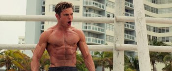 Movie still from “Baywatch” (2017), directed by Seth Gordon – A man with his mouth wide open looking at the camera; Medium shot, Low angle