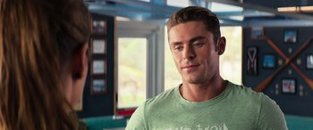 Movie still from “Baywatch” (2017), directed by Seth Gordon – A person wearing a green shirt; Close Up shot, Over the shoulder angle